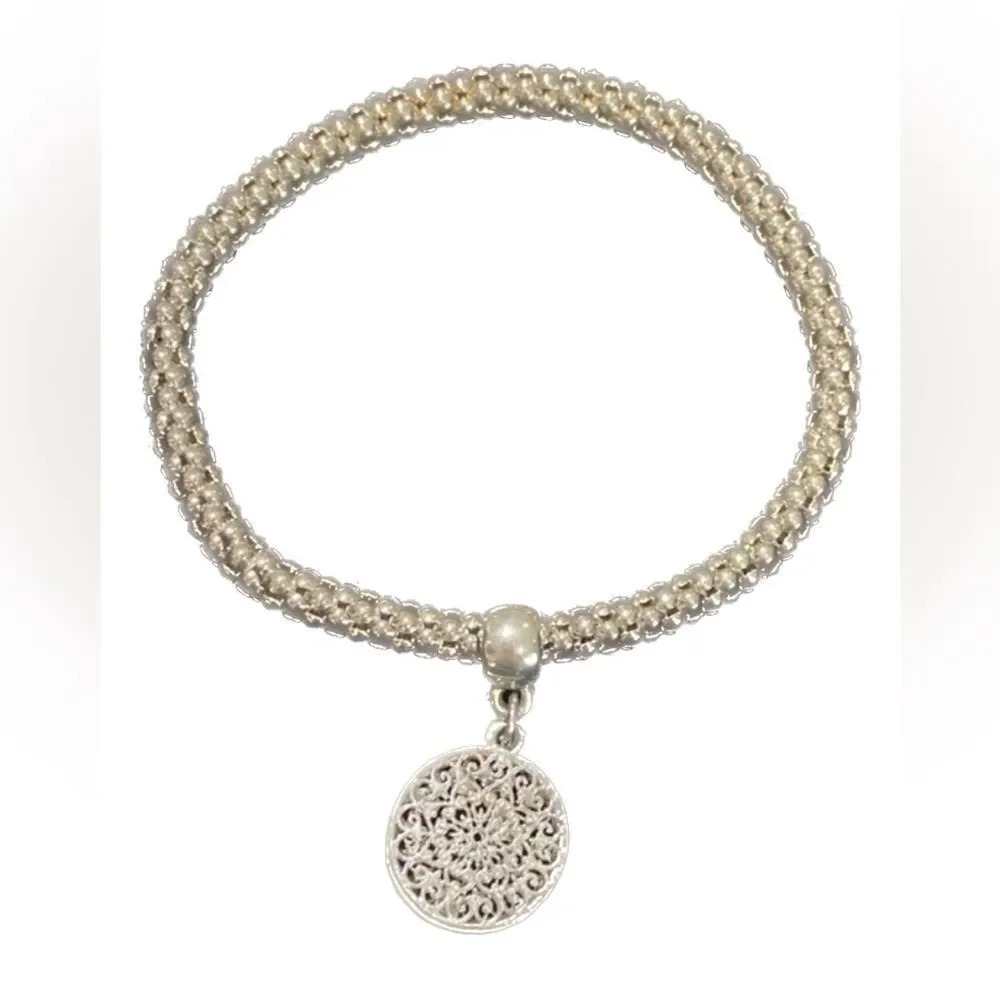 Silver tone bracelet with charm